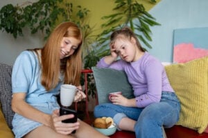 teen babysitter helping child while learning babysitting safety skills