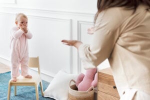 Babysitter leading indoor games with a toddler at home